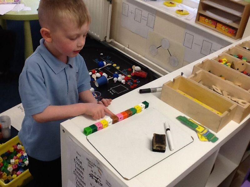 boy using cubes for maths