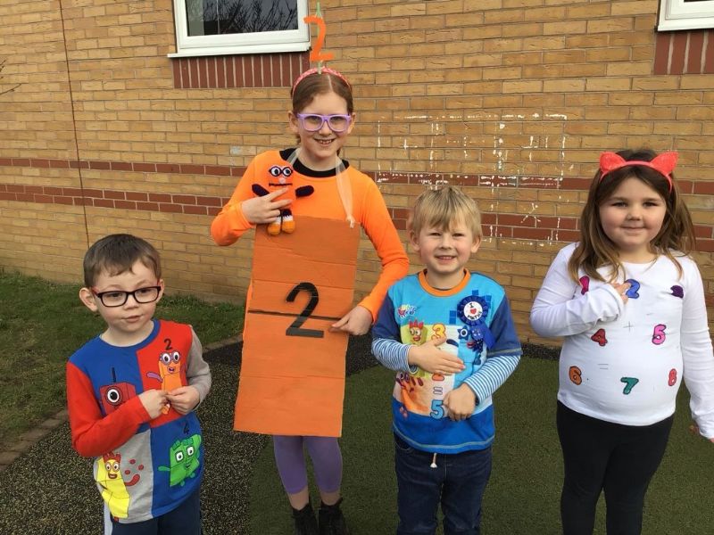 four children dressed up in number-related clothes